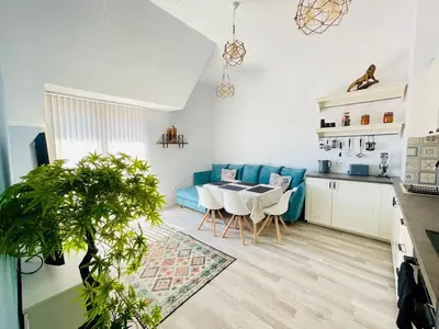 a living room with a blue couch and a table at 2BR Vintage Residence - free parking in Varna City