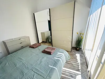 a bedroom with a bed and a large mirror at 2BR Vintage Residence - free parking in Varna City