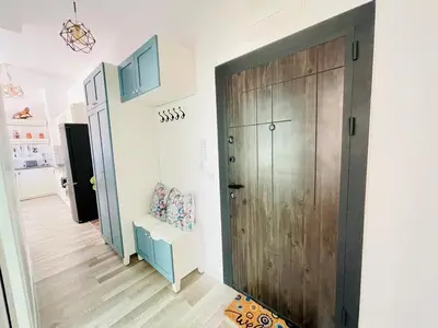 a hallway with a wooden door in a house at 2BR Vintage Residence - free parking in Varna City