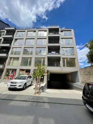 a white car parked in front of a building at 2BR Vintage Residence - free parking in Varna City