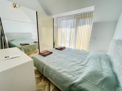 a bedroom with a large bed with a mirror at 2BR Vintage Residence - free parking in Varna City