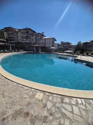a large blue swimming pool in front of some buildings at Etara 4 in Sveti Vlas