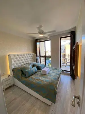 a bedroom with a large bed and a balcony at Harmony 20 in Sveti Vlas