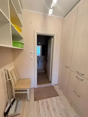 a small room with a chair and a bathroom at Эстебан с 2 спальнями in Nesebar