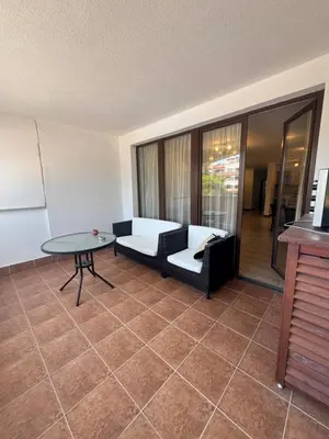 a living room with a couch and a table at Каса реал с 2 спальнями 2 этаж in Sveti Vlas