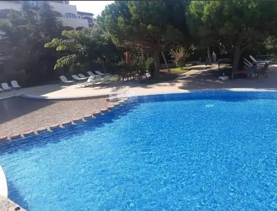 a swimming pool with blue water in a resort at Каса реал с 2 спальнями 2 этаж in Sveti Vlas