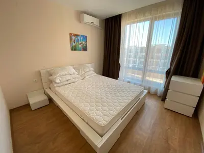 a bedroom with a bed and a large window at Premier Fort Beach in Sveti Vlas
