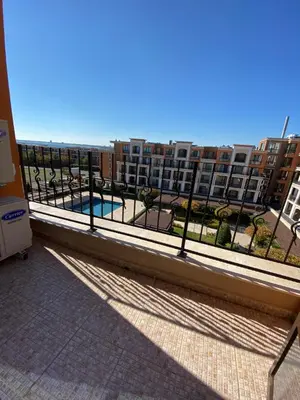 a balcony with a view of a pool and buildings at Premier Fort Beach in Sveti Vlas