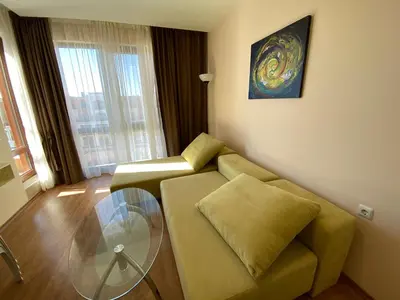 a living room with a couch and a glass table at Premier Fort Beach in Sveti Vlas