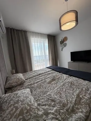 a bedroom with a bed and a large window at Ипанемма с 1 спальней корпус А in Sveti Vlas