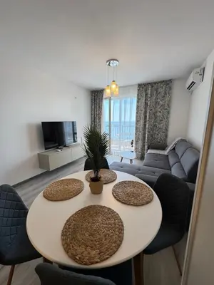a living room with a table and a couch at Ипанемма с 1 спальней корпус А in Sveti Vlas