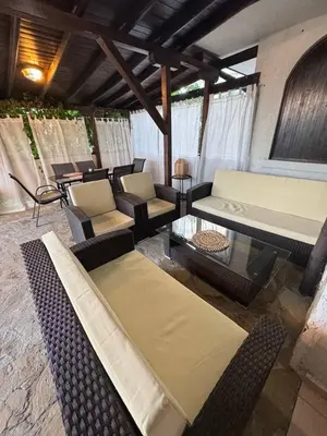 a living room with couches and chairs and a table at Kombani 3 in Sveti Vlas