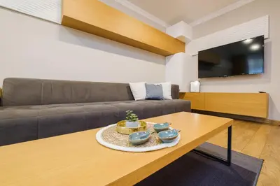 a living room with a couch and a table at Sam Centre Harmony 1-Bedroom in Burgas City