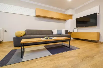 a living room with a couch and a coffee table at Sam Centre Harmony 1-Bedroom in Burgas City