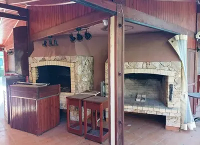 a kitchen with a large stone fireplace in a room at Rainbow 2 Aparthotel Complex in Sunny Beach