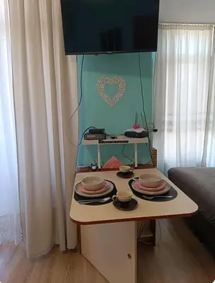 a table with plates on it in a room at Rainbow 2 Aparthotel Complex in Sunny Beach
