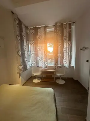 a bedroom with a window with two chairs and a table at Apartment in Sunny Fort in Sunny Beach