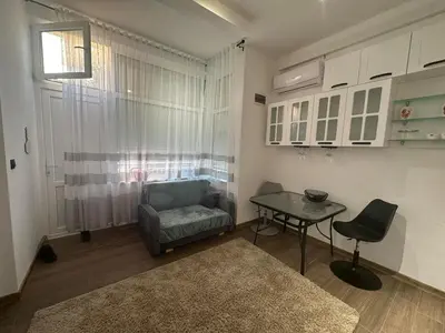 a living room with a chair and a table at Apartment in Sunny Fort in Sunny Beach