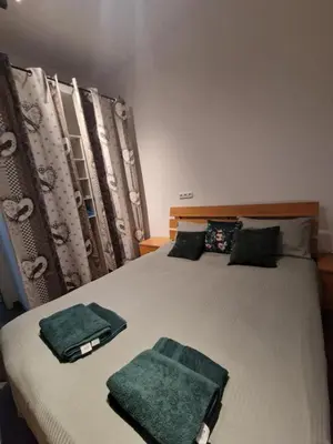 a bedroom with two beds with green towels on them at Apartment in Sunny Fort in Sunny Beach