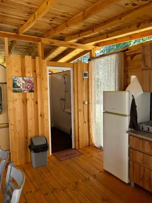 a kitchen with a refrigerator and a door to a room at Каравана Рубин in Chernomorets