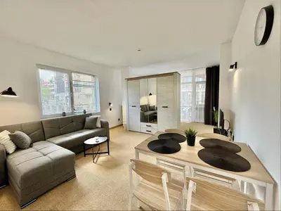 a living room with a couch and a table at Carina Beach - Menada Apartments in Sunny Beach