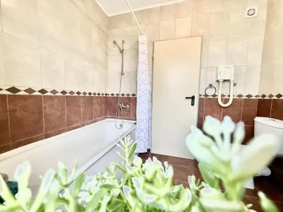 a bathroom with a bath tub and a toilet at Carina Beach - Menada Apartments in Sunny Beach