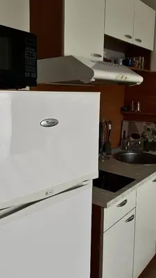 a white kitchen with a sink and a microwave at Sunny Beach Fort Noks Orchid Apartment in Sunny Beach