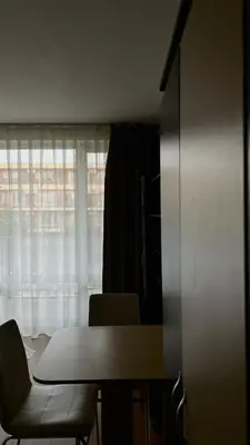 a table and chair in a room with a window at Sunny Beach Fort Noks Orchid Apartment in Sunny Beach