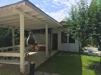 a wooden pergola with a table and a grill at Villa Elmar in Kiten