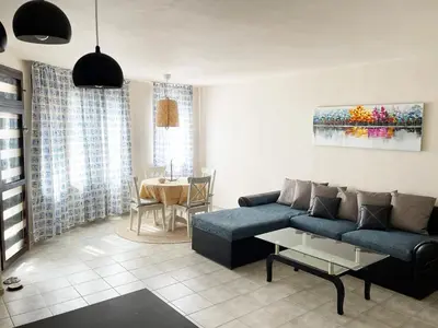 a living room with a blue couch and a table at Cozy apartment at the heart of Burgas in Burgas City