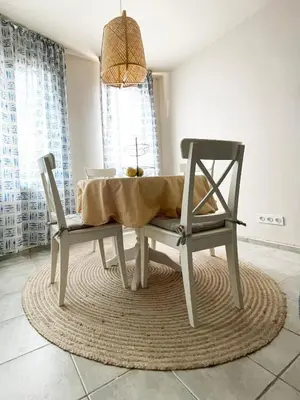 a dining room table with a chair and a table and a table and chairswana at Cozy apartment at the heart of Burgas in Burgas City