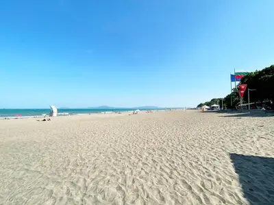 a beach with footprints in the sand and the ocean at Cozy apartment at the heart of Burgas in Burgas City