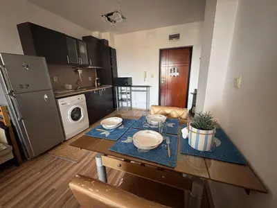a kitchen with a table with plates on it at Линоляни in Pomorie
