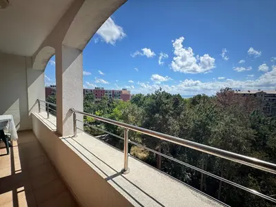 a balcony with a view of trees and buildings at Линоляни in Pomorie