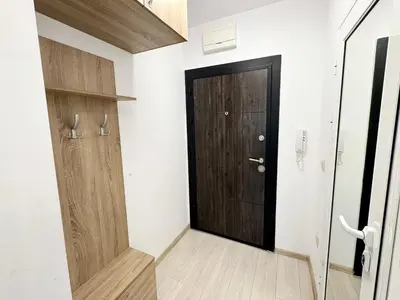 a hallway with a black door and white walls at Sweet tiny house-central studio in Varna City