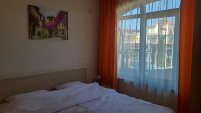 a bedroom with a bed and a window with a view at 1BD Apartment in Royal Sun Complex, Sunny Beach by Flat Mаnager in Sunny Beach