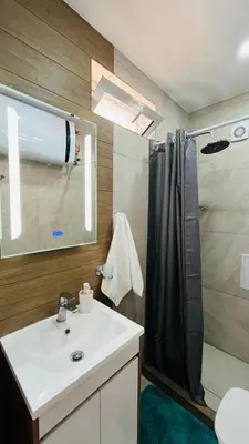 a bathroom with a shower and a white sink at JADORE Secret Garden Panoramic Studio in Sunny Beach