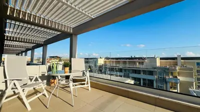 a balcony with chairs and a table on a roof at JADORE Secret Garden Panoramic Studio in Sunny Beach