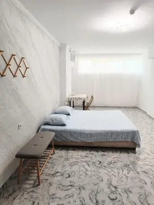 a bedroom with two beds and a table in it at Sol e Mar Sunny Beach in Sunny Beach