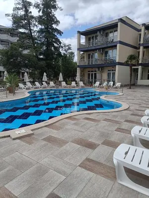 a swimming pool in front of a building at Sol e Mar Sunny Beach in Sunny Beach