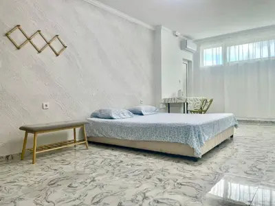 a bedroom with a bed and a table in it at Sol e Mar Sunny Beach in Sunny Beach