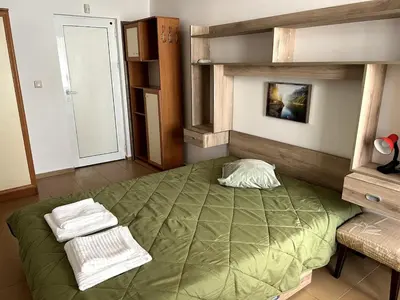 a bedroom with a large green bed in a room at Central 1BR Apartment Near Cathedral in Varna City