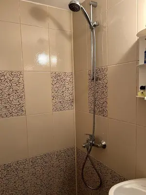 a shower with a glass door in a bathroom at Central 1BR Apartment Near Cathedral in Varna City