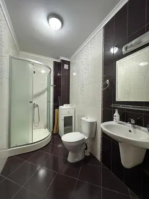 a bathroom with a toilet and a sink and a shower at Boulevard Sea Residenz in Sunny Beach