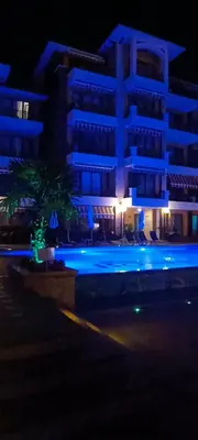 a building with blue lights in front of a building at Boulevard Sea Residenz in Sunny Beach