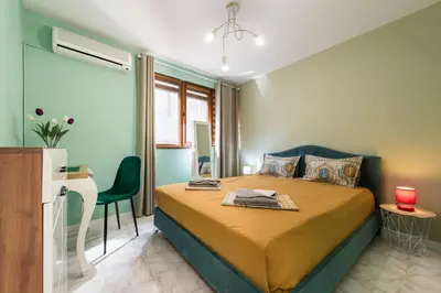 a bedroom with a bed and a desk in it at Dany's Apartments in Varna City