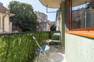 a patio with two chairs and a table on a balcony at Dany's Apartments in Varna City