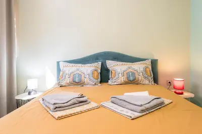 a bed with towels and pillows on top of it at Dany's Apartments in Varna City
