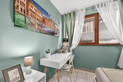 a bedroom with a desk and a bed and a window at Dany's Apartments in Varna City
