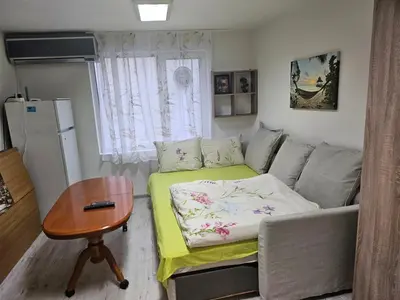 a small living room with a couch and a table at Гарсониера в центъра на град Бургас in Burgas City